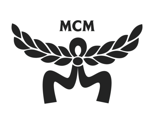 MCM emblem: a central circle with stylized wings/wreath extending outward, the letters MCM above in bold serif font