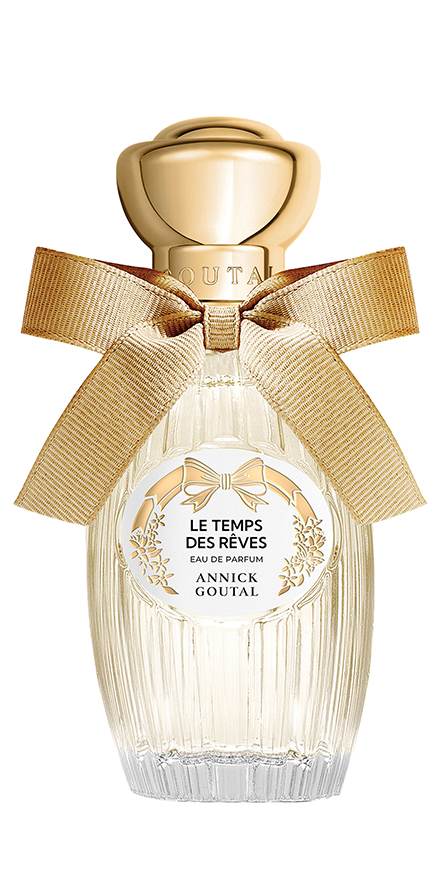 Perfume bottle with a gold cap and large beige ribbon, label reads ‘Le Temps des Rêves’ by Annick Goutal